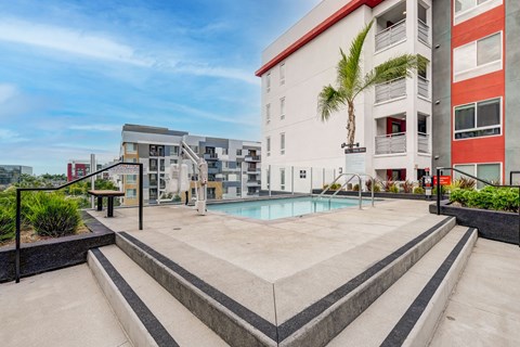 A modern building with a pool in the foreground.